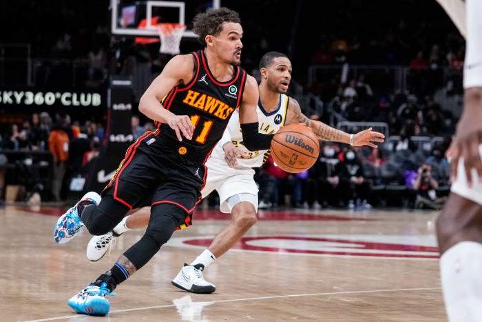 Feb 8, 2022; Atlanta, Georgia, USA; Atlanta Hawks guard Trae Young (11) dribbles ahead of Indiana Pacers guard Keifer Sykes (28) during the second half at State Farm Arena.